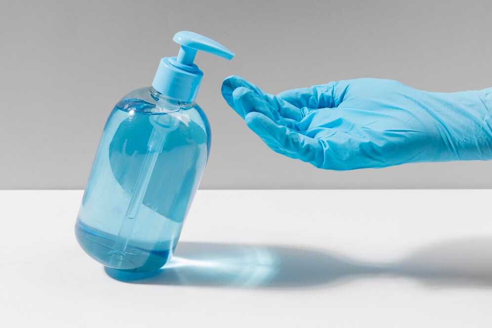 hand-with-surgical-glove-using-hand-sanitizer_23-2148561070